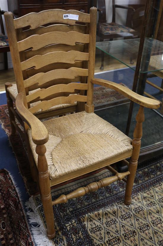 A set of eight early 20th century oak ladder back cottage dining chairs, with rush seats, including two carvers